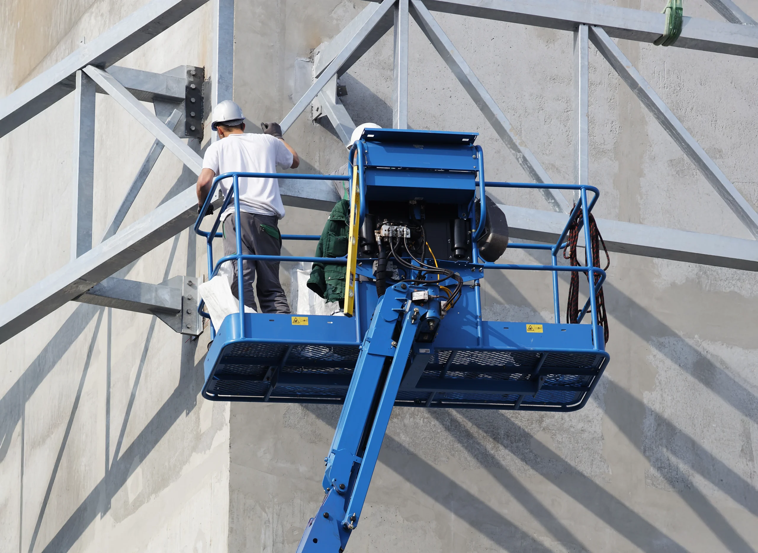 Access Equipment Two Men in Scissor Lift Working on Building Exterior