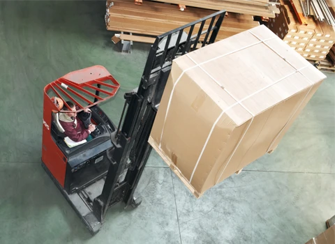 Fork lift lifting brown package box up