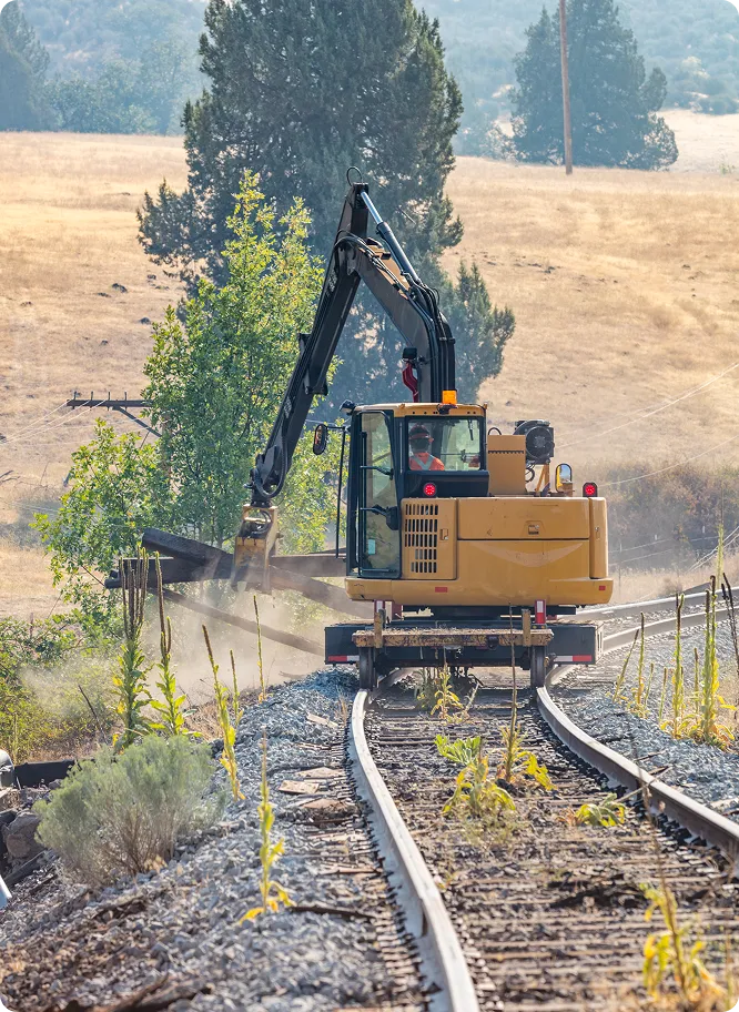 Railroad Equipment -Cribbing Clam Bucket on Tracks 