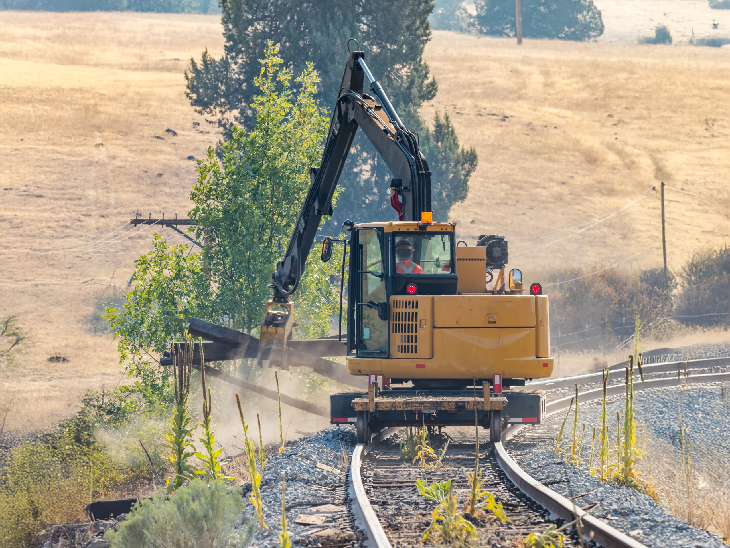 Railroad construction equipment crane on the tracks working 
